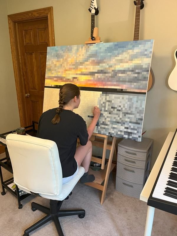 Anna working on a landscape painting