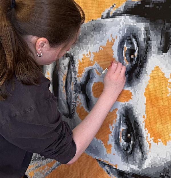Anna working on a pixel painting
